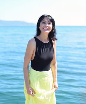 45 years old Russian woman laughing and looking away against Japanese sea