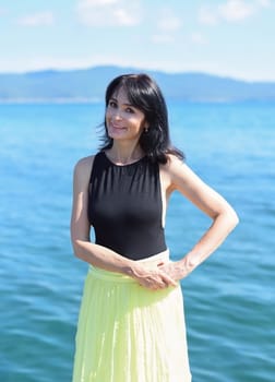 45 years old Russian woman laughing and looking away against Japanese sea