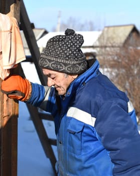 Portrait of old Russian man looking left, tired of work
