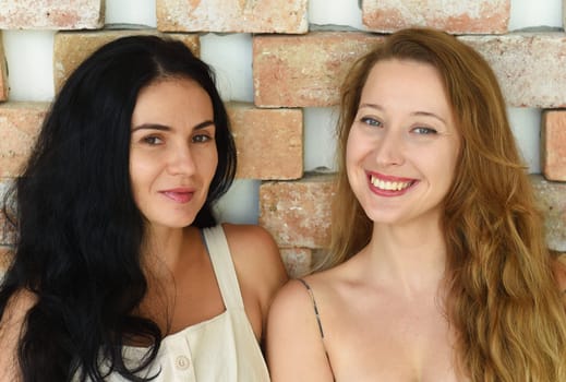 Ukrainian woman (brunette) and Russian woman (blond) portrait together with long hair