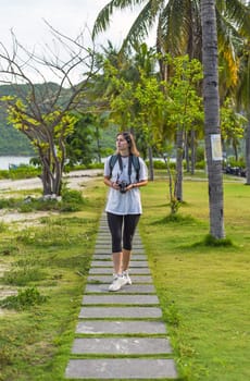 Cute  photographer and  travel blogger taking a photo with camera in summer