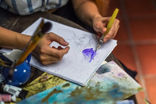 Woman artist and illustrator drawing sketches by penci