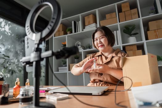 A beauty influencer smiles while demonstrating a skincare serum on a live stream, captivating her audience with product details in her modern workspace.