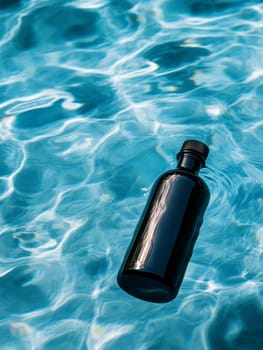 glass bottle of water on swimming pool background ..