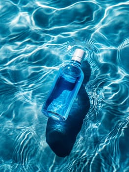 glass bottle of water on swimming pool background ..