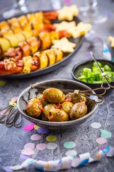 Carnival food, long sausages wrapped in yeast dough, corn dog with mustard and olives 