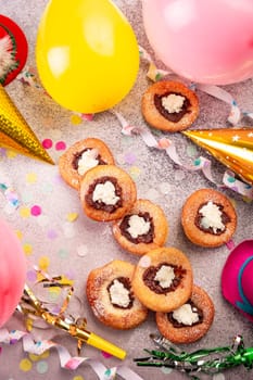 Carnival powdered sugar raised donuts with jelly and cream cheese, paper streamers and confetti