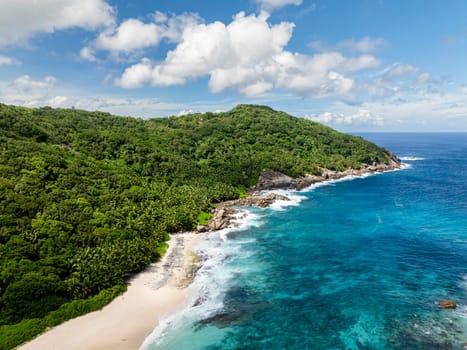 Aerial view of Rocks in the ocean and a beautiful beach in the Seychelles.
