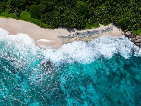 Beautiful sandy beach and ocean with waves. Seychelles, Mahe. Anse Petit Boileau.