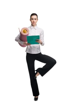 Business woman in white tshirt with green paper pack and mat isolated shot