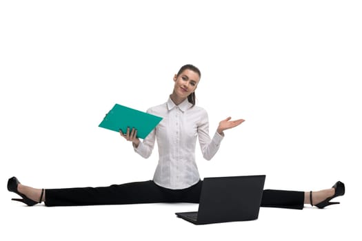 Business woman in white tshirt with green paper pack and notebook sitting on the floor isolated shot
