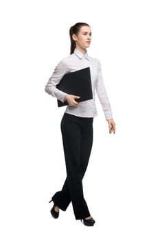 Business woman in white tshirt and black trousers with notebook isolated shot