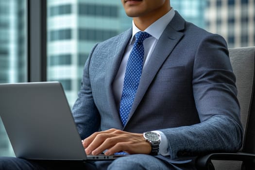 Businessman wearing suit and tie using laptop in office with skyscraper view