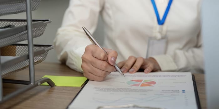 A business team collaborates on an essential document review to enhance productivity in a professional office setting.