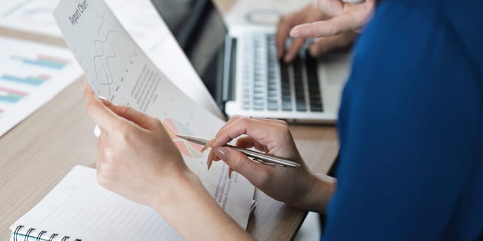A dedicated business team reviewing reports and discussing data insights, emphasizing analytical skills and teamwork in a contemporary office setting.