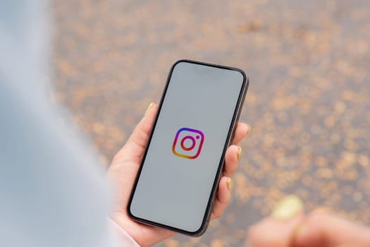 CHIANG MAI, THAILAND - January 27,2025 : A woman holds Apple iPhone with Instagram application on the screen. Instagram is a photo sharing app for smartphones.