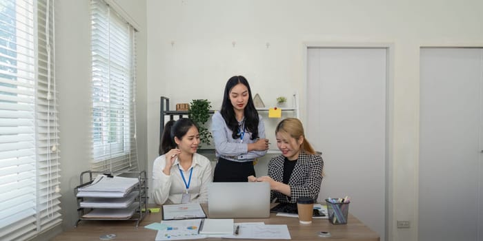 A focused team collaborates in a bright office discussing strategies and enhancing business productivity together.