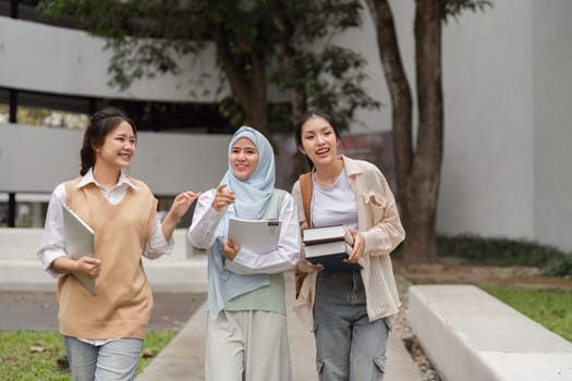 A group of diverse university students walking together and engaging in cheerful conversation while enjoying their time on campus.