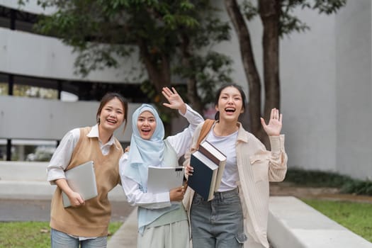 A group of diverse university students joyfully waving at the camera, celebrating their friendship and vibrant campus life.