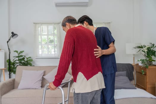 A compassionate nurse assists an elderly man using a walker in a comfortable home environment, demonstrating care and support during mobility.