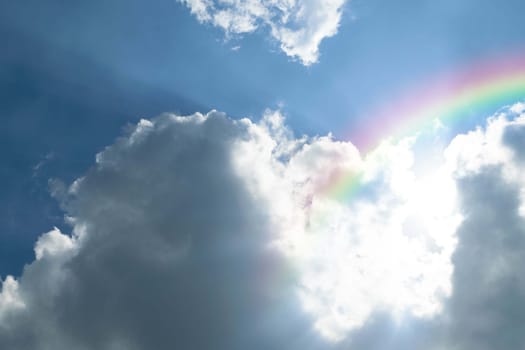 Cloudscape rainbow of natural sky with blue sky and white clouds and colorful rainbow in the sky use for wallpaper background