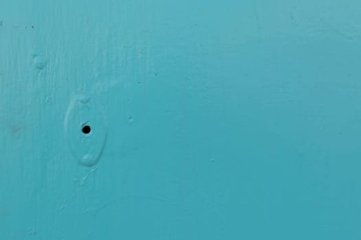 Minimalism style, Metal door blue color locked with padlock texture background.