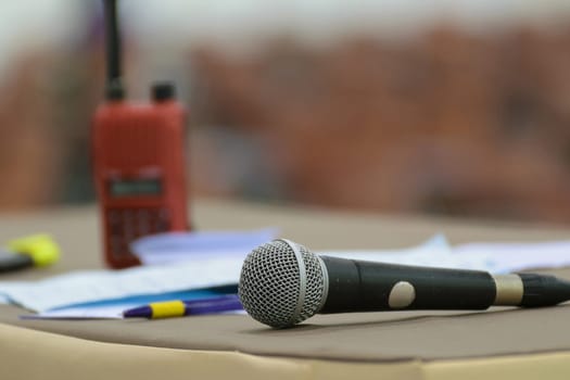 Microphone in seminar event defocus on walkie talkie (radio communication) and meeting room background