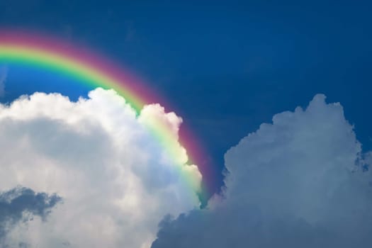 Cloudscape rainbow of natural sky with blue sky and white clouds and colorful rainbow in the sky use for wallpaper background