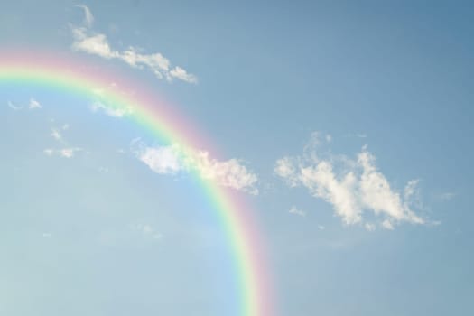 Nature cloudscape with blue sky and white cloud with rainbow