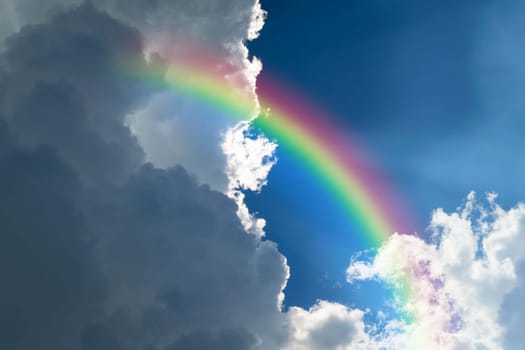Cloudscape rainbow of natural sky with blue sky and white clouds and colorful rainbow in the sky use for wallpaper background