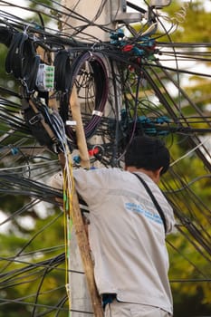 Bangkok, Thailand - November 16, 2015 : Unidentified worker working to install internet fiber system in village at Bangkok Thailand.