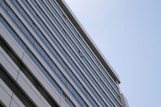 Big glass building with blue sky and white cloud
