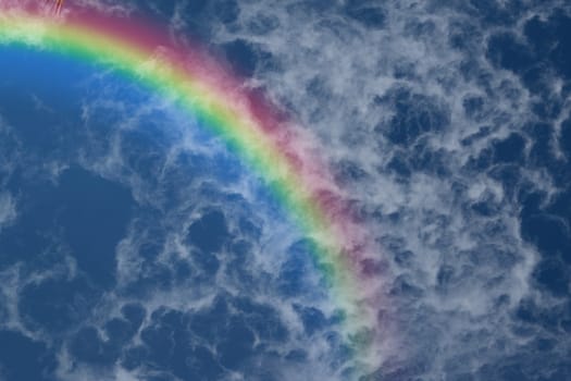 Nature cloudscape with blue sky and white cloud with rainbow