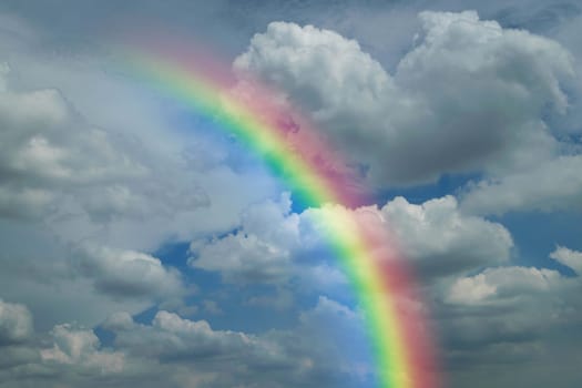 Cloudscape rainbow of natural sky with blue sky and white clouds and colorful rainbow in the sky use for wallpaper background