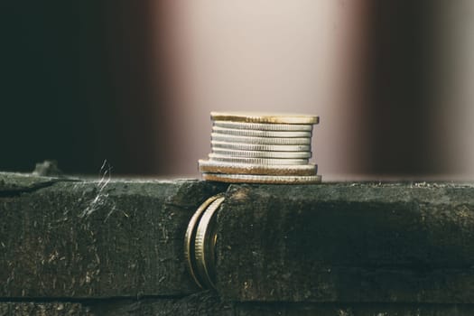 Thai coin stacked on a wood table , process in vintage style