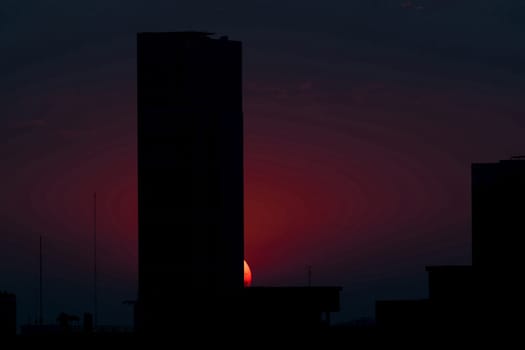 Evening Sky with Sunset and silhouette building in city