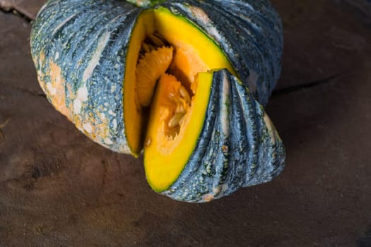 Pumpkin is a fresh vegetable have a green and yellow color on a wooden table