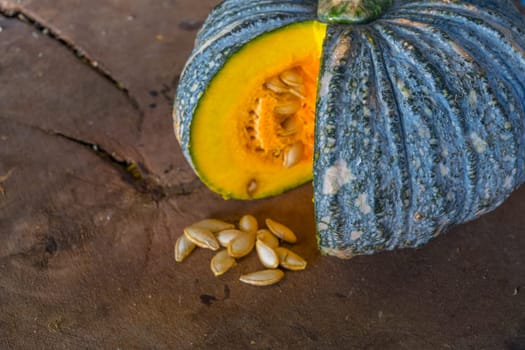 Pumpkin is a fresh vegetable have a green and yellow color on a wooden table