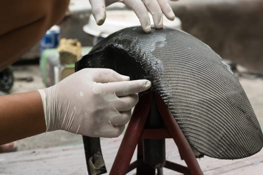 Wrapping carbon fiber or kevlar and man hand for working