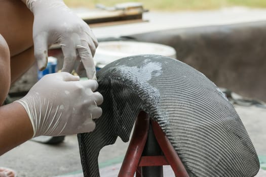 Wrapping carbon fiber or kevlar and man hand for working