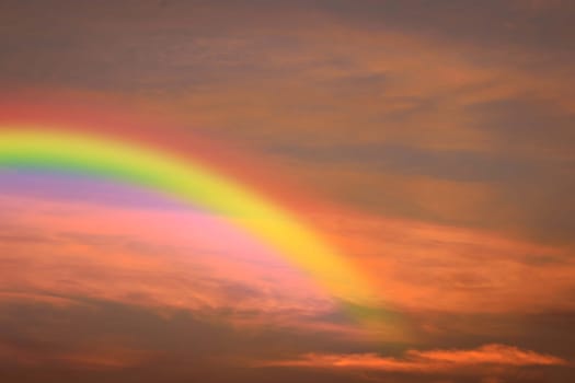 Cloudscape rainbow of natural sky with red sky and white clouds and colorful rainbow in the sky use for wallpaper background
