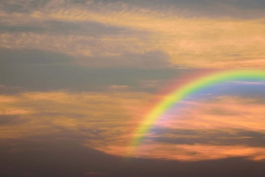 Cloudscape rainbow of natural sky with red sky and white clouds and colorful rainbow in the sky use for wallpaper background