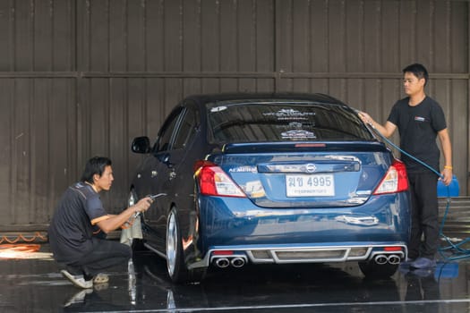 Bangkok, Thailand - December 12, 2015 : Unidentified car care staff cleaning the car.