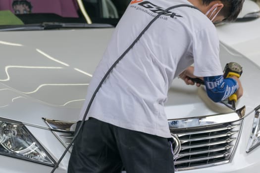 Bangkok, Thailand - December 12, 2015 : Unidentified car care staff cleaning the car.
