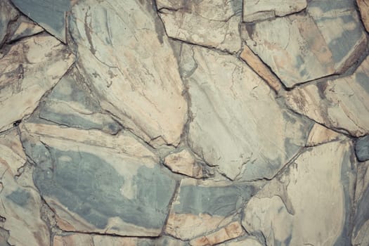 Stone wall texture background surface natural color , process in vintage style