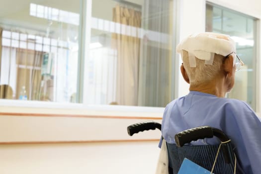 Patient elderly man with head injury on wheelchair in hospital