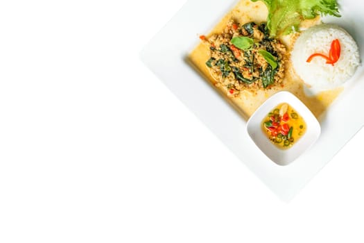 Rice topped with stir-fried pork and basil isolated on white background