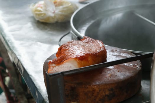 Cooking chinese egg noodles with red pork