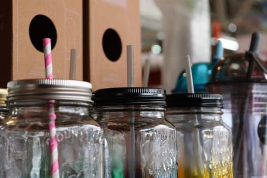Colorful empty jar with straw