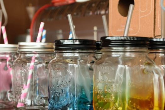 Colorful empty jar with straw